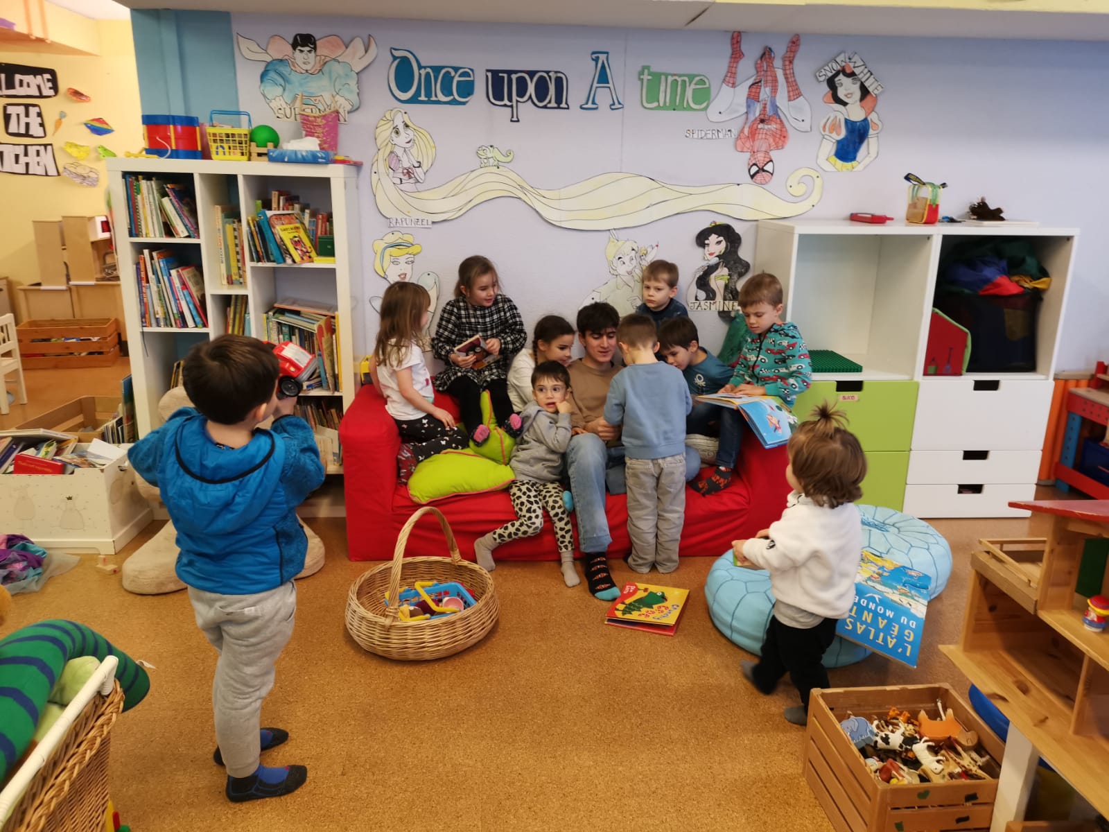Children gathered with a teacher for story time in the cosy reading corner at Cogmo Kids